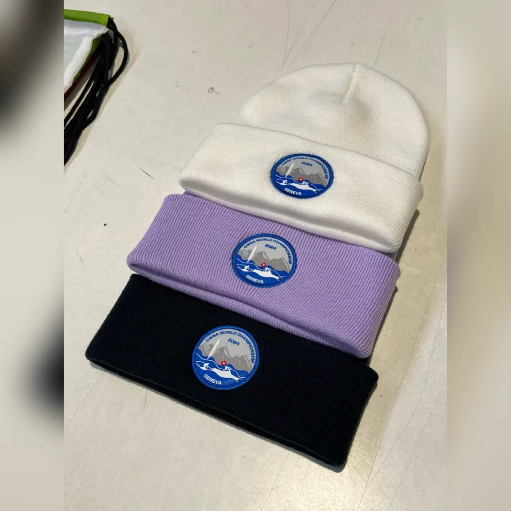 Bonnets à revers blanc, lavande et noir avec un écusson rond bleu